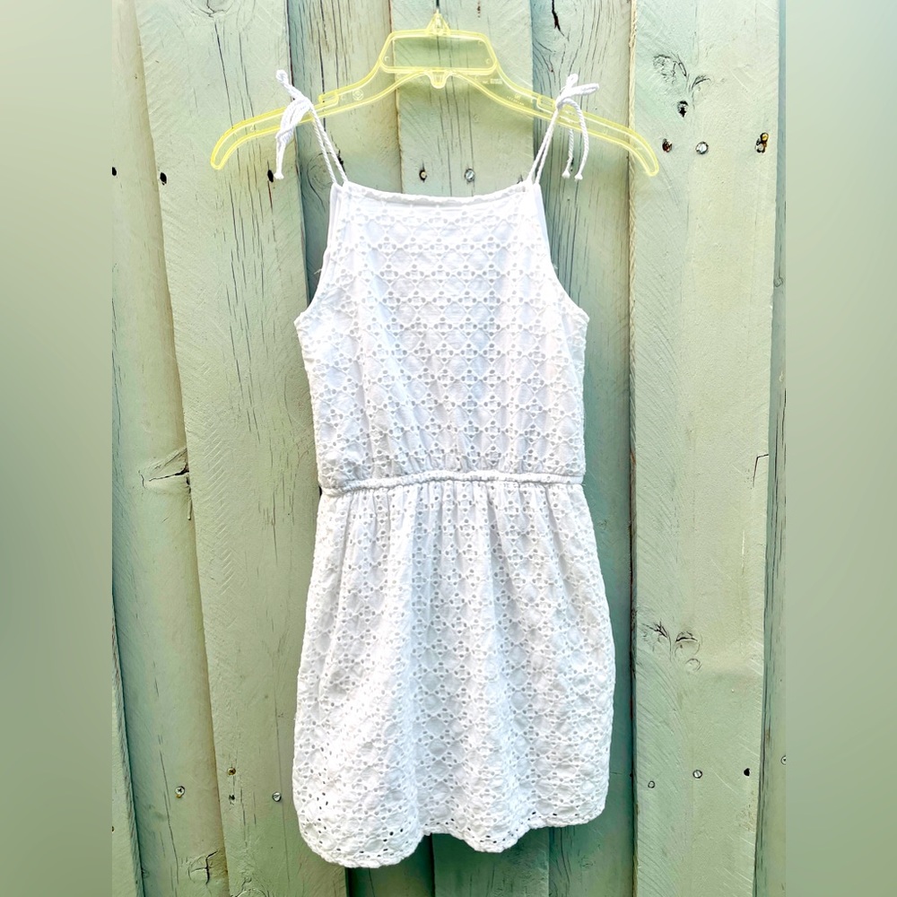 Pretty young girls, white eyelet dress with lining & white tassels in the front.